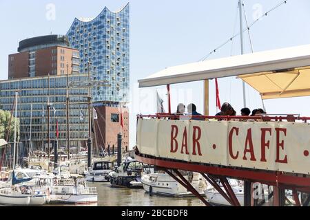 The Elbphilharmonie in Hamburg with the terrace of a restaurant boat in the foreground