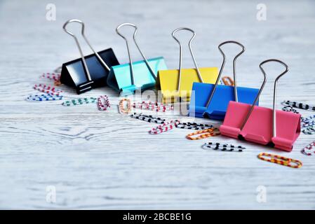Color paperclips and paper clips on an aged white background Stock Photo