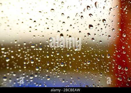 Background raindrops on the glass with colored stripes Stock Photo
