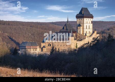 Karlstejn, Czech republic - April 01, 2020: Karlstejn castle in winter time in warm morning sun Stock Photo