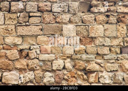 Ancient collapsing brick wall close up as background Stock Photo