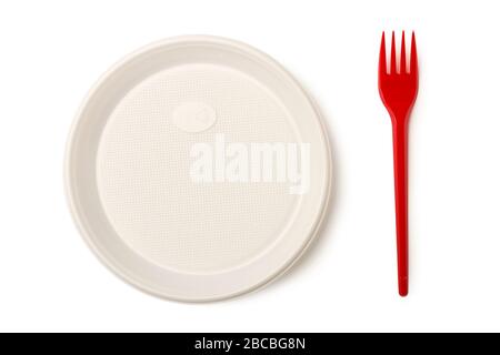 Disposable plastic plate and red plastic fork isolated on white background Stock Photo