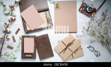 Mockup view from the top. Composition for photographers and wedding agencies. On the table is a wooden box for photographs, a retro camera, envelopes Stock Photo