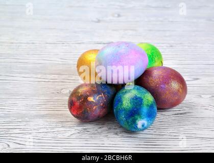 Colored eggs on a gray background lie in the shape of a pyramid Stock Photo