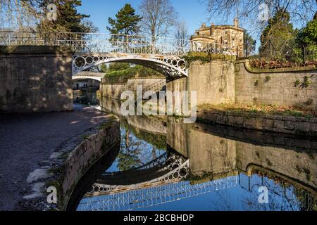 Two Grade II listed decorative iron footbridges over the Kennet and Avon Canal at Sydney Gardens, Bath, Somerset England Uk Stock Photo