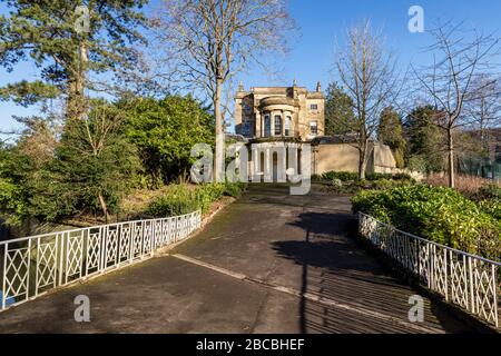 A Grade II listed decorative iron footbridge over the Kennet and Avon Canal leads to Sydney House at Sydney Gardens, Bath, Somerset England Uk Stock Photo
