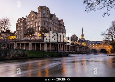 The Empire Hotel near Pulteney Bridge with the Colonnade under Newmarket Row and the Pulteney weir on the River Avon, Bath, England Uk Stock Photo