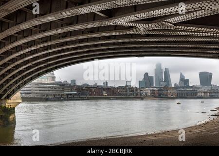 Skyline of the  City of London framed under Blackfriars Railway Bridge, London, England Stock Photo