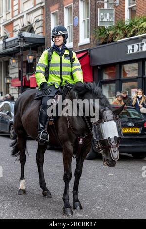 Metropolitan Police Officer on horseback patrolling in Covent Garden, London