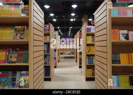 Aisle between shelves of library books, in an education background like ...