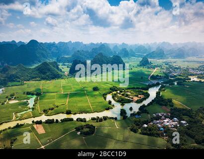 Rural Chinese landscape of limestone rocks and scenic river around rice fields in Guangxi province Stock Photo