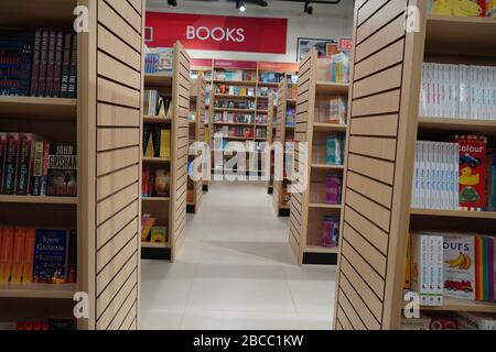 Aisle between shelves of library books, in an education background like ...