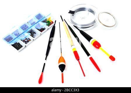 Box with fishing accessories, floats, fishing line in reels on a white background close-up Stock Photo