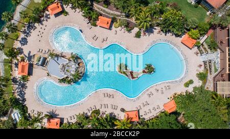 A typically busy Florida resort style pool is now empty during the busiest part of the year due to corona virus covid 19 beach and pool closures. Stock Photo