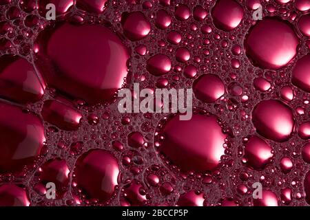 Beautiful abstract foam purple and pink bubbles on dark black background