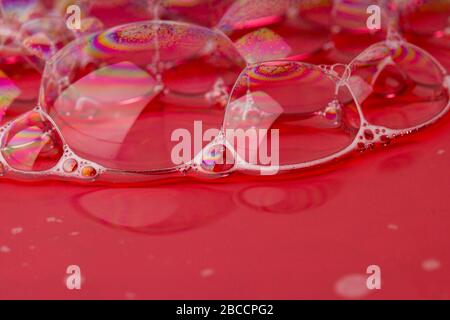 Red Background Of Suds Bubbles. Close up Stock Photo