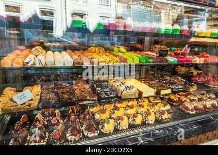 Display of a candy store with a great assortment of cakes and macaroons in Amsterdam, Netherlands Stock Photo