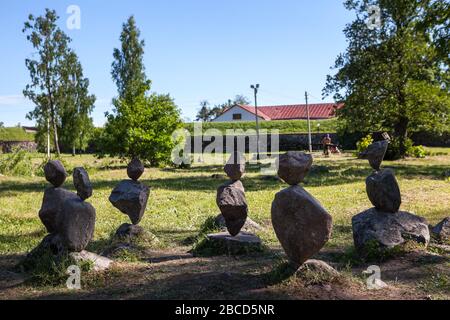 Several balanced pyramids from pebbles standing in urban park. Priozersk town, Russia Stock Photo