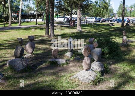 Balanced pyramids from pebbles standing in urban park at the entrance to the Korela Fort or Kexholm Fortress. Priozersk town, Russia Stock Photo