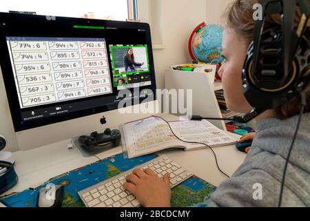 Boy, primary school children, home learning, doing homework, distance learning, virtual classroom, chat with teachers and classmates, home schooling, Stock Photo
