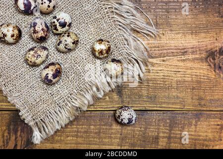 Close-up photo of fresh organic quail eggs on rustic background. Top view, copy space. Easter holidays concept. Stock Photo