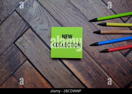 New Collection write on a sticky note isolated on wooden table. Stock Photo