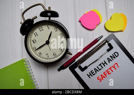 Health and Safety? write on a paperwork isolated on wooden table. Stock Photo