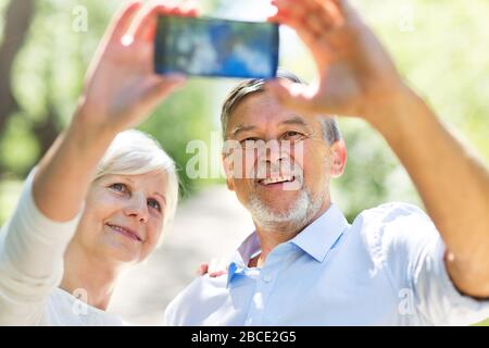 Senior Couple Sitting Park Stock Photo