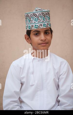 Traditional Omani sword dancers perform with musicians demonstrating inherited skills at Nizwa Fort, Nizwa, Oman Stock Photo