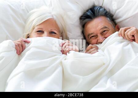 Senior couple in bed together Stock Photo