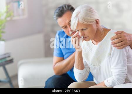 Senior Man Consoling Wife Stock Photo