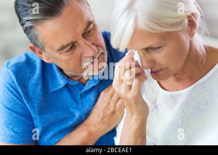 Senior Man Consoling Wife Stock Photo