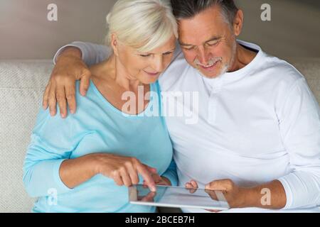 Senior couple using laptop Stock Photo