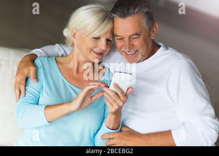 Senior couple using mobile phone Stock Photo