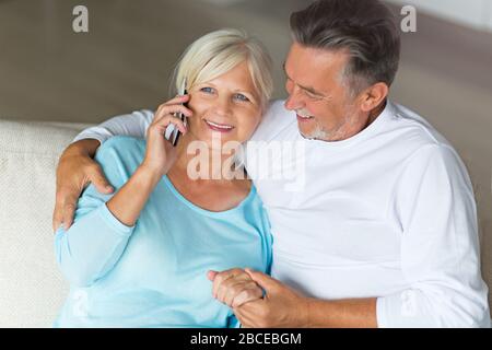 Senior couple using mobile phone Stock Photo