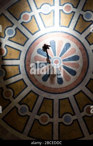 High-angle view of a woman crossing the decorated floor inside the National Pantheon (formerly the Church of Santa Engrácia), Lisbon Stock Photo