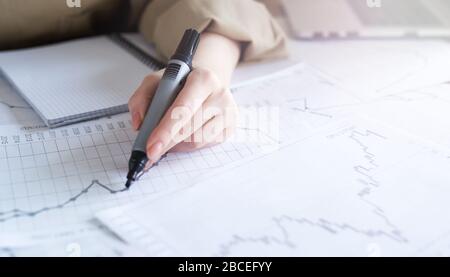 Close up woman hand working of Business graphics, analysis. Startup Stock Photo