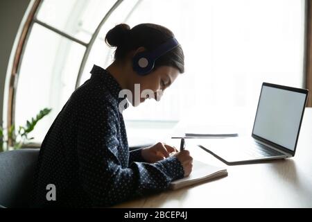 Happy young indian woman enjoying studying remotely from home. Stock Photo