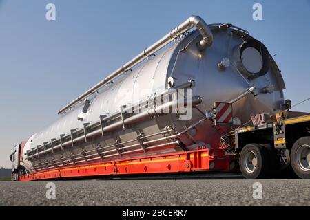 A truck with a special semi-trailer for transporting oversized loads. Oversize load or exceptional convoy. Stock Photo