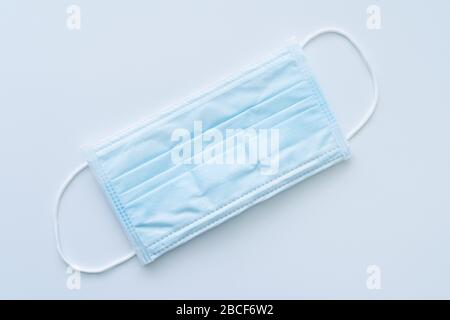 Typical 3 ply surgical face mask with rubber ear straps. Stock Photo