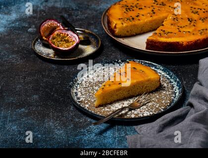 Piece of upside down mango upside down cake with passion fruit and caramel. Summer tropical dessert. Selective focus. Copy space. Stock Photo