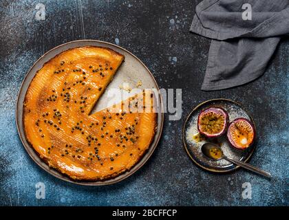 Top view of fresh baked mango upside down cake with passion fruit and caramel. Homemade sweet food concept. Stock Photo