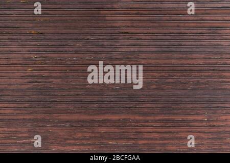 Old large wooden shutters with many slats and chipped paint Stock Photo