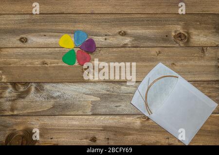 acoustic guitar accessories, strings, picks on wooden background Stock Photo