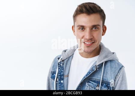 Close-up portrait of handsome sassy, confident gay man with beaming smile, blond hair and blue eyes, look camera determined, feeling proud during Stock Photo