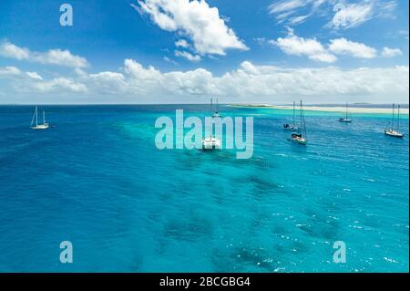 Sailing yacht anchoring in the shallow waters of suwarrow atoll, cook islands, polynesia, pacific ocean Stock Photo