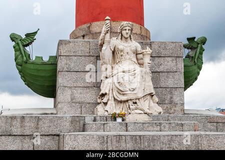 Sculpture at the foot of the Rostral column on the arrow of Vasilievsky island in a cloudy summer house. Stock Photo