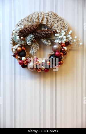 A festive wreath of Christmas baubles as a Christmas decoration. A decorative Christmas wreath that glitters on the wall. Stock Photo