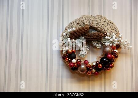 A festive wreath of Christmas baubles as a Christmas decoration. A decorative Christmas wreath that glitters on the wall. Stock Photo