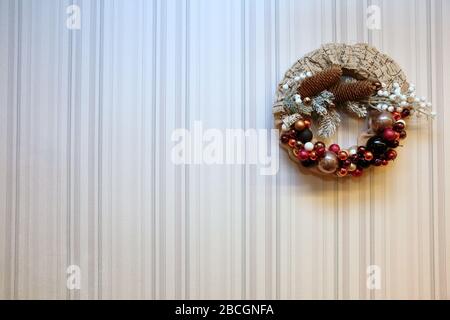 A festive wreath of Christmas baubles as a Christmas decoration. A decorative Christmas wreath that glitters on the wall. Stock Photo